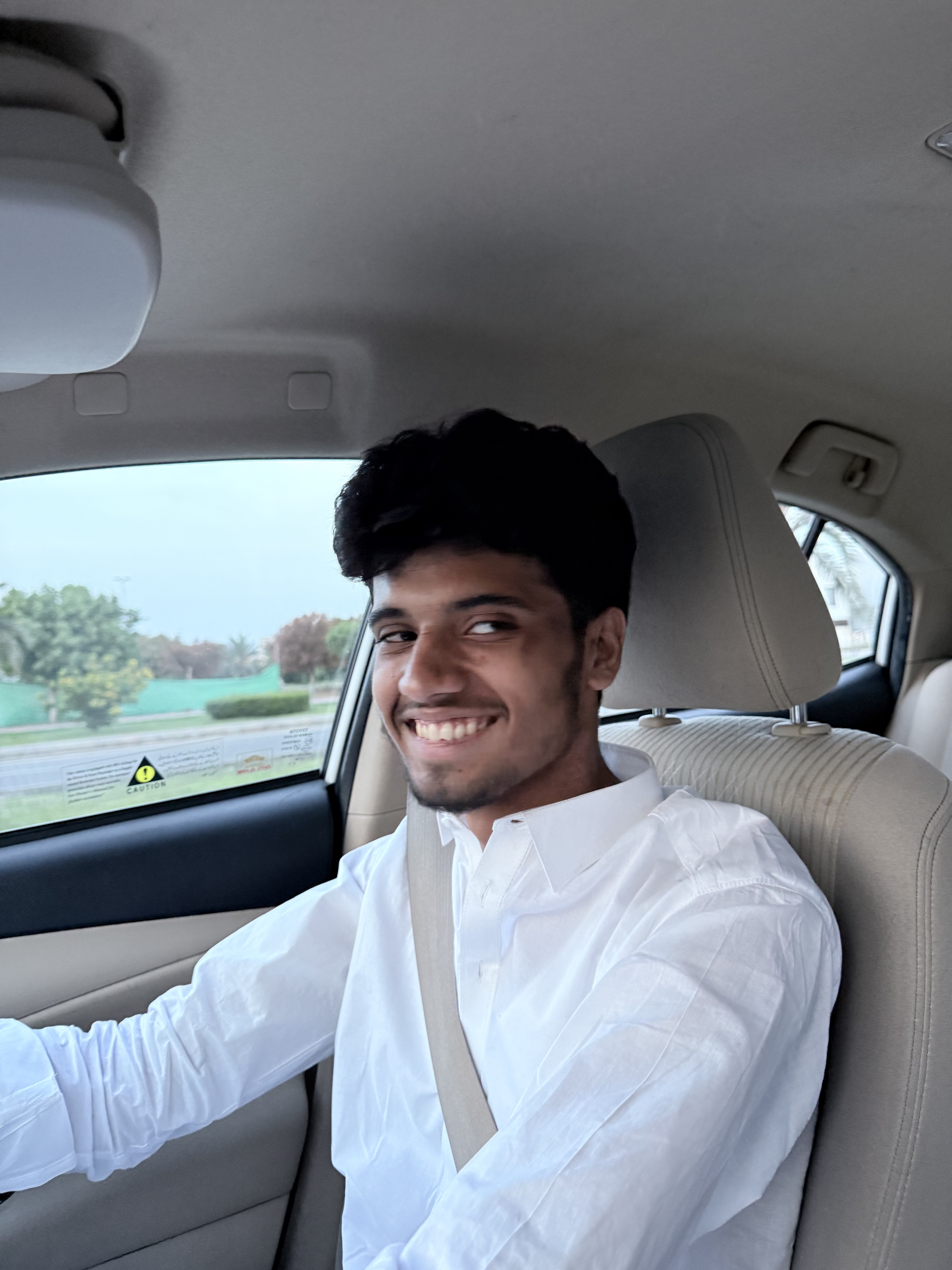 Abdullah Hamid smiling while driving